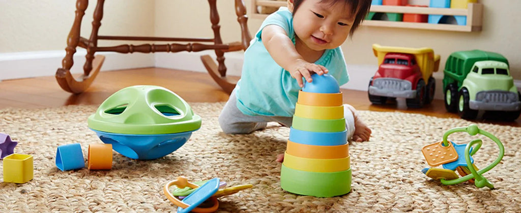 child playing with green toys